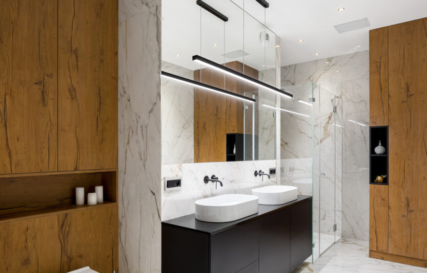 Stylish bathroom interior in wood and marble with two basins and big shower