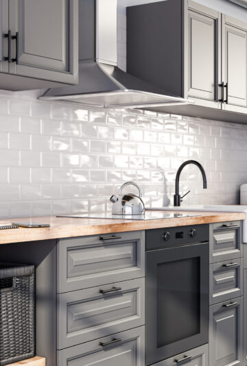 Scandinavian open style kitchen in grey color, white tiles